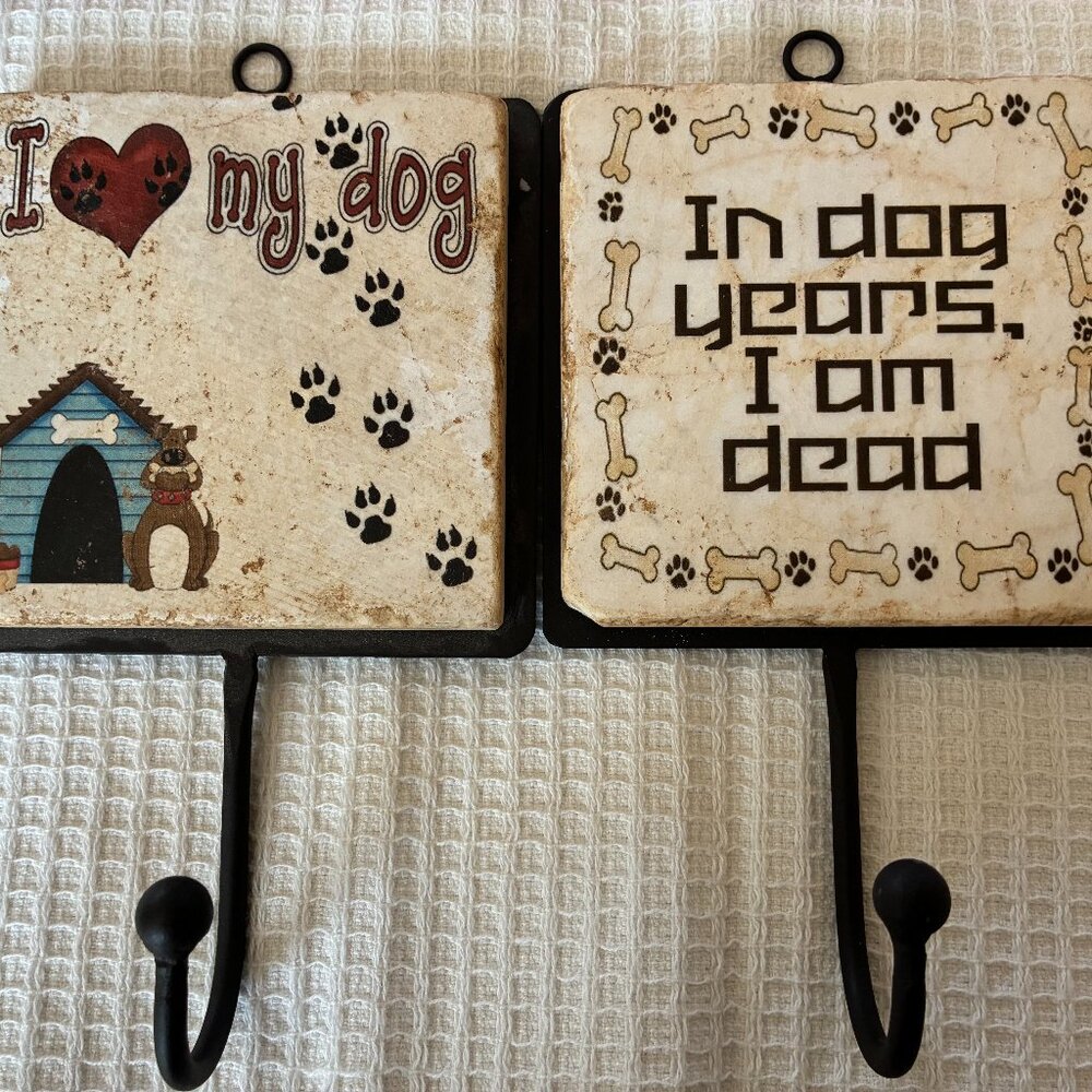 Two Italian marble dog-themed wall hooks